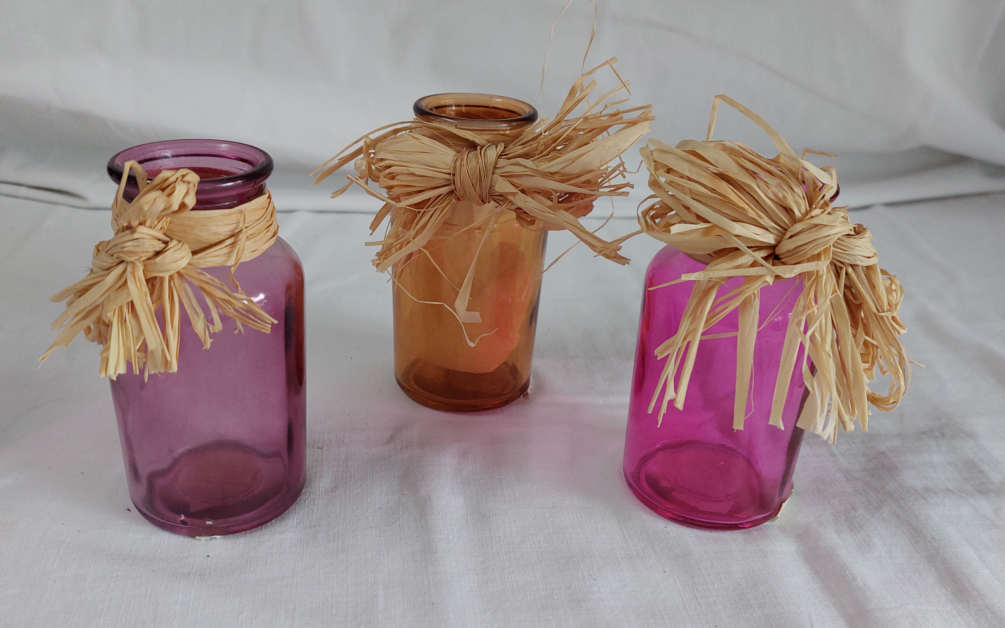 Small colourful glass vase with Raffia Bow £3.99 each
