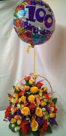 Birthday flowers .silk flowers in basket with balloon