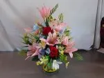 Silk flower arrangement inside grave pot 